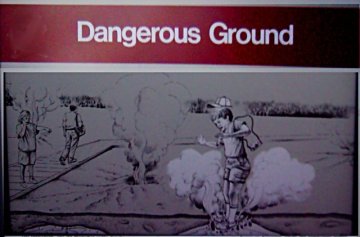 Sign:Dangerous Ground -with illustration of kid falling into ground and getting broiled-